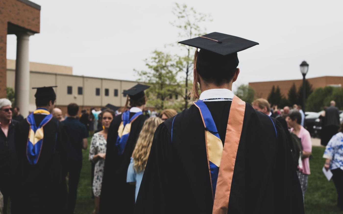 man wearing academic gown by Charles DeLoye courtesy of Unsplash.