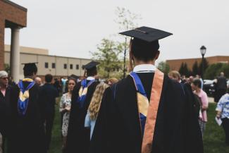 man wearing academic gown by Charles DeLoye courtesy of Unsplash.