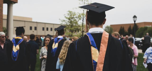 man wearing academic gown by Charles DeLoye courtesy of Unsplash.